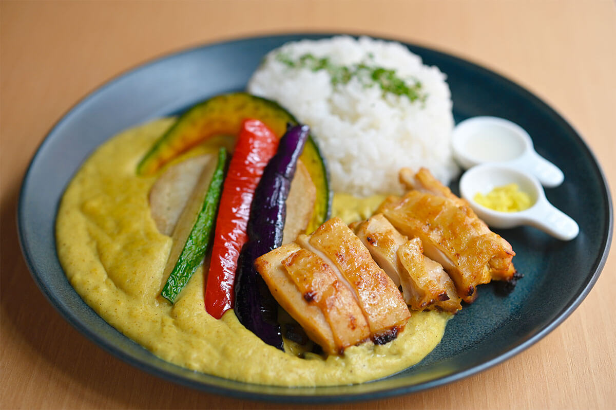 Haccomachi特製 甘酒としょっつるのココナッツカレー 980円。ココナッツミルクがベースなので、子どもでも食べやすい優しい味ですが、魚醤「しょっつる」が優しいカレーに深みを加えてくれます。別添えされた「甘酒」をかけて味の変化も楽しんで